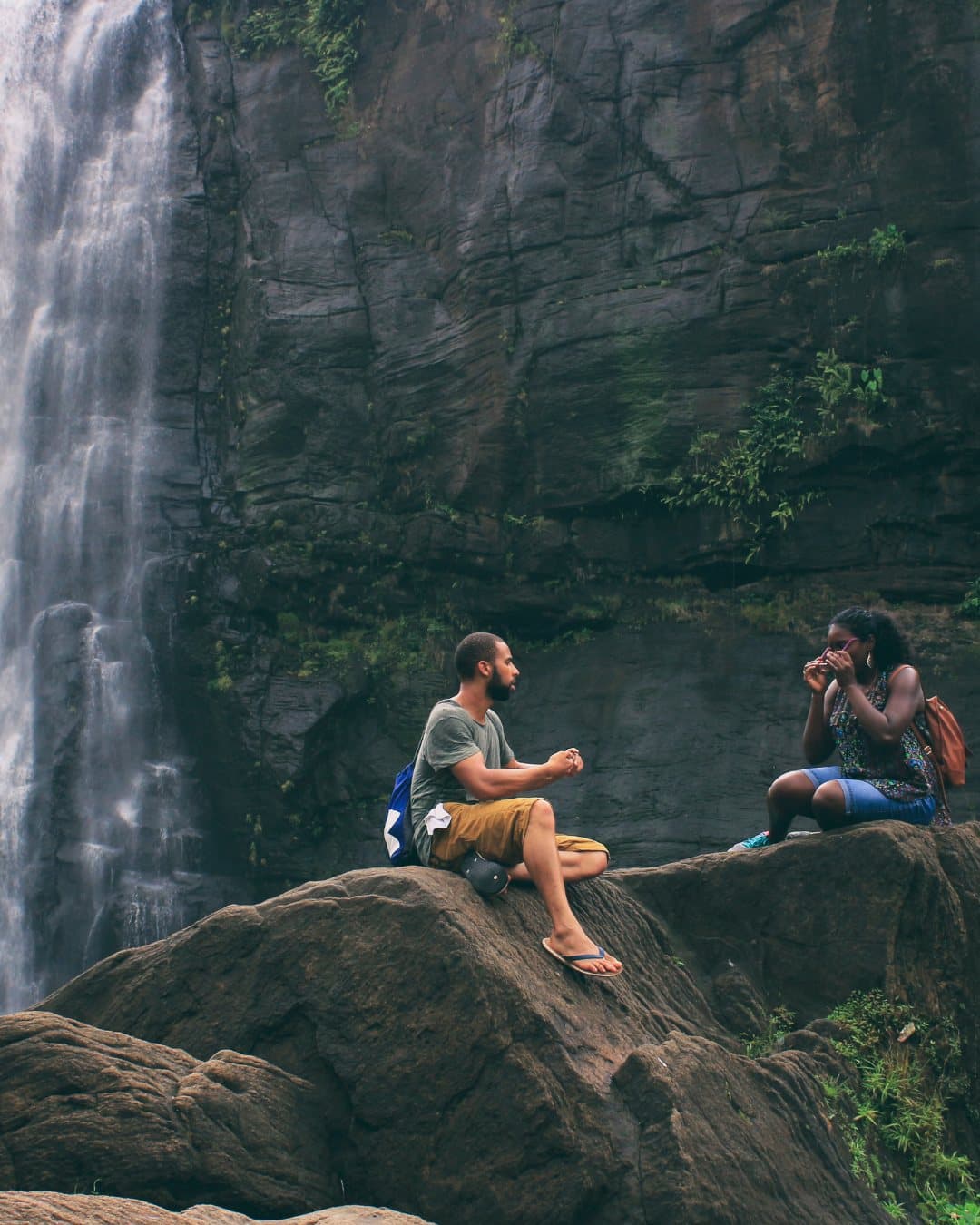 Men talking at the base of a waterfall in Chiapas